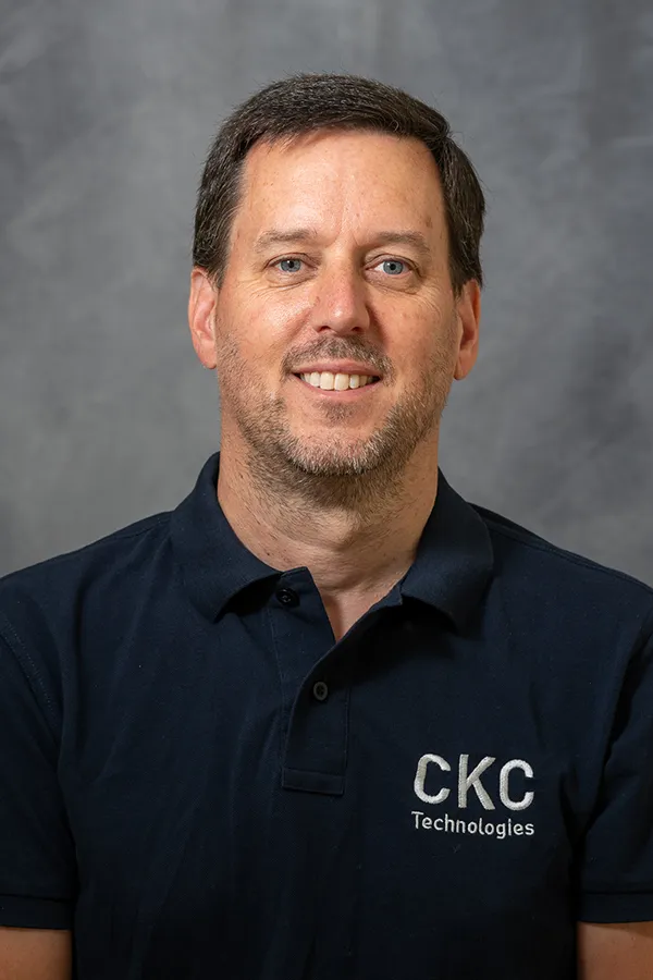 Headshot of Glenn Bailey wearing a CKC Technologies Blue T-Shirt