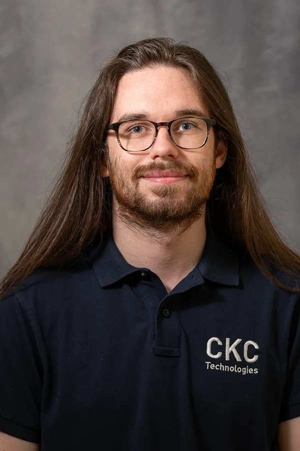 Headshot of Kieran Franklin-Bailey wearing a CKC Technologies Blue T-Shirt